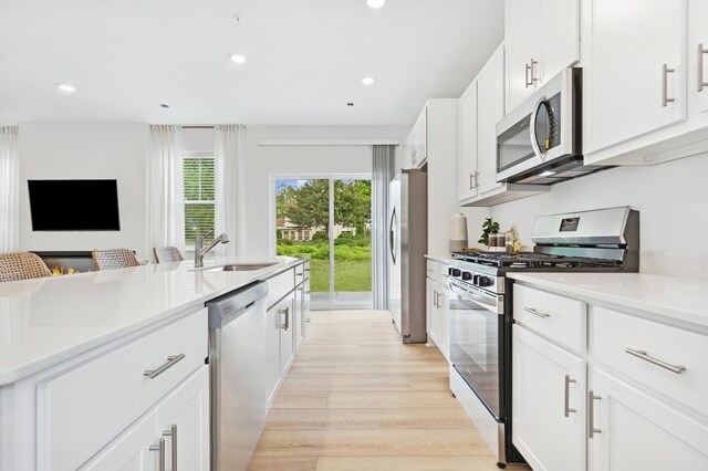 5413 Queens Dr NW, Rochester, MN 55901 - kitchen featuring stainless steel appliances, light wood finished floors, white cabinetry, recessed lighting, and light stone countertops