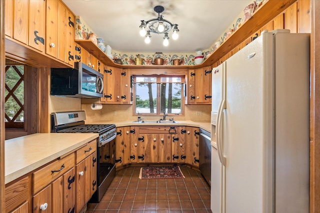 25761 Echo Bay Rd, Bay Lake Twp, MN 56444 - kitchen featuring appliances with stainless steel finishes, light countertops, and dark tile patterned floors