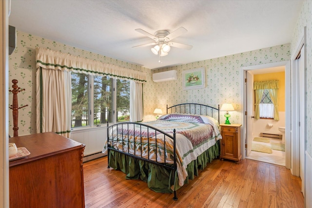 25761 Echo Bay Rd, Bay Lake Twp, MN 56444 - bedroom with wallpapered walls, light wood-style flooring, a baseboard radiator, a wall mounted air conditioner, and a baseboard heating unit