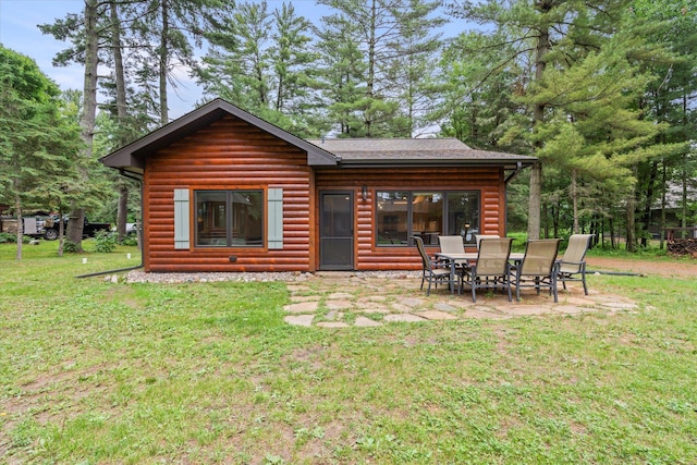 25761 Echo Bay Rd, Bay Lake Twp, MN 56444 - back of property with a lawn, log veneer siding, and a patio