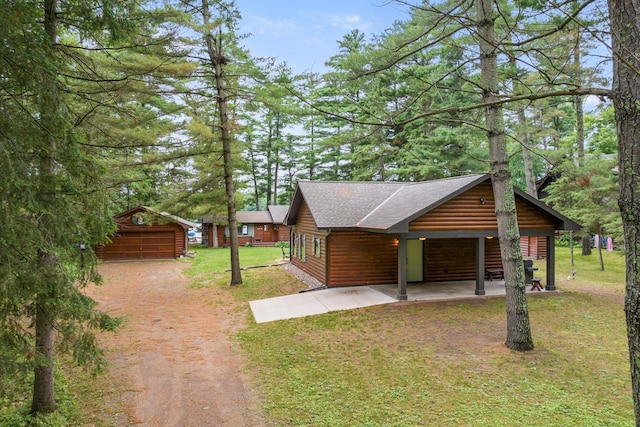 25761 Echo Bay Rd, Bay Lake Twp, MN 56444 - view of property exterior with an outdoor structure, a lawn, log veneer siding, a shingled roof, and a garage