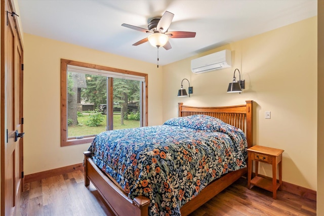 25761 Echo Bay Rd, Bay Lake Twp, MN 56444 - bedroom with a wall mounted AC, wood finished floors, and ceiling fan