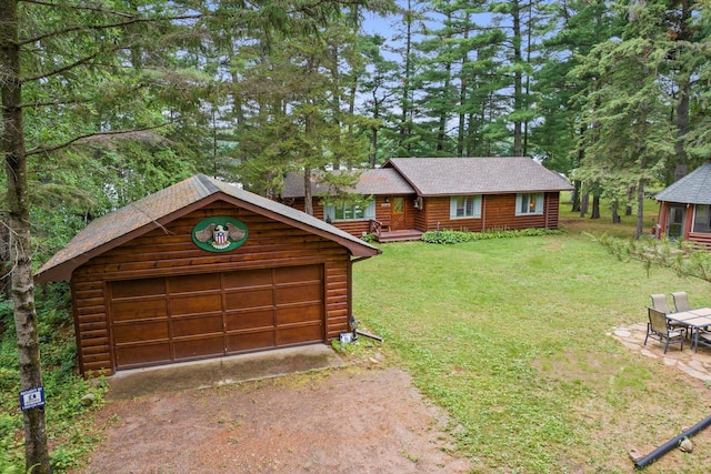 25761 Echo Bay Rd, Bay Lake Twp, MN 56444 - view of front of property featuring an outbuilding, a front lawn, driveway, faux log siding, and a shingled roof