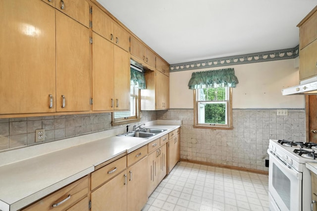 8775 County Road 10 E, Waconia, MN 55387 - kitchen featuring light flooring, light countertops, a wainscoted wall, white gas range oven, and under cabinet range hood