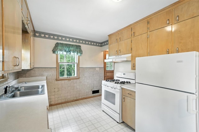 8775 County Road 10 E, Waconia, MN 55387 - kitchen featuring white appliances, under cabinet range hood, light countertops, wainscoting, and light floors