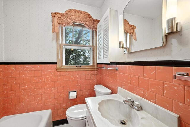 8775 County Road 10 E, Waconia, MN 55387 - bathroom with a wainscoted wall, wallpapered walls, vanity, a bathtub, and tile walls