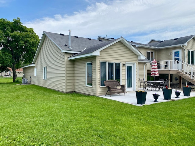 6333 Vera Cruz Ln N, Brooklyn Park, MN 55429 - rear view of house featuring a patio, a yard, stairway, and a deck