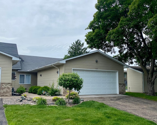 6333 Vera Cruz Ln N, Brooklyn Park, MN 55429 - ranch-style home featuring asphalt driveway, a garage, a front lawn, and roof with shingles