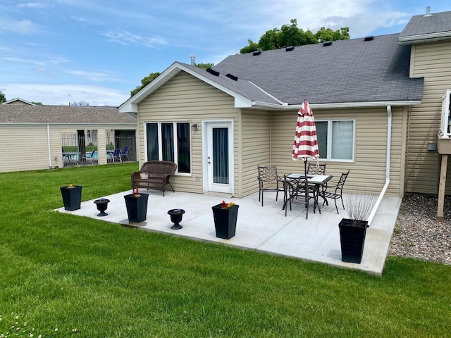 6333 Vera Cruz Ln N, Brooklyn Park, MN 55429 - rear view of house with a lawn, a patio, and a shingled roof
