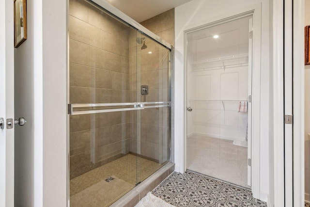 146 Maple Ter, Waconia, MN 55387 - full bathroom with a shower stall, a spacious closet, and tile patterned flooring