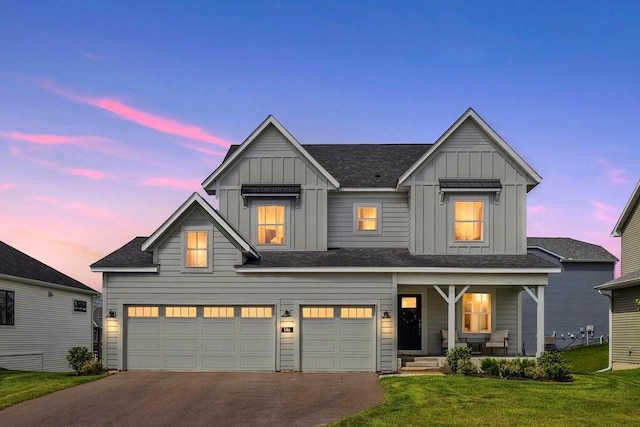 146 Maple Ter, Waconia, MN 55387 - modern farmhouse style home featuring board and batten siding, covered porch, a front lawn, a garage, and driveway