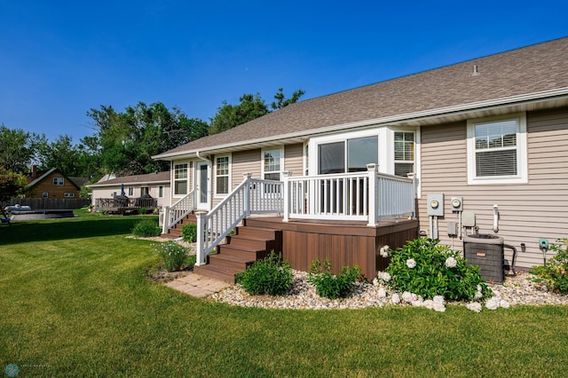 210 1st St, Arthur, ND 58006 - back of house featuring a wooden deck, a yard, and a shingled roof