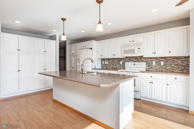 210 1st St, Arthur, ND 58006 - kitchen with white appliances, light wood finished floors, decorative backsplash, and recessed lighting