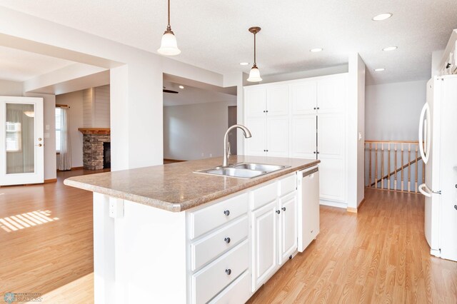 210 1st St, Arthur, ND 58006 - kitchen featuring white appliances, light wood-style floors, decorative light fixtures, white cabinets, and recessed lighting
