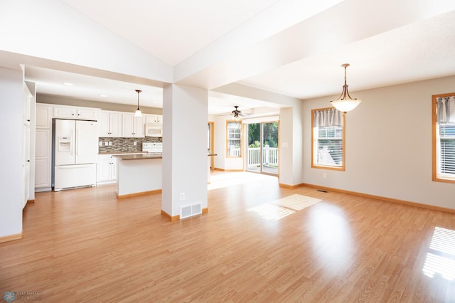 210 1st St, Arthur, ND 58006 - unfurnished living room featuring ceiling fan, light wood-style floors, and lofted ceiling