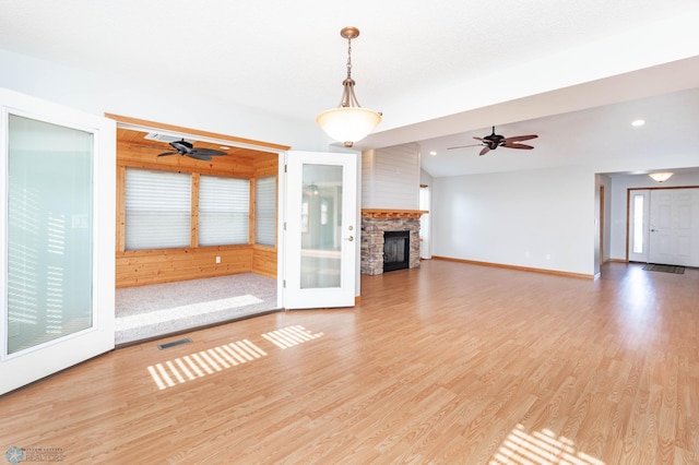 210 1st St, Arthur, ND 58006 - unfurnished living room featuring ceiling fan, light wood finished floors, a fireplace, and recessed lighting