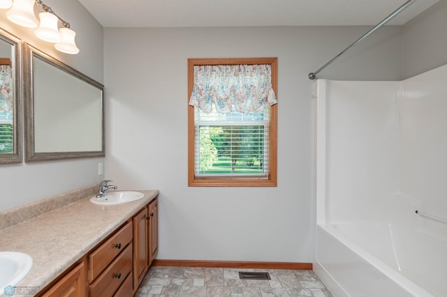210 1st St, Arthur, ND 58006 - bathroom with double vanity and tub / shower combination