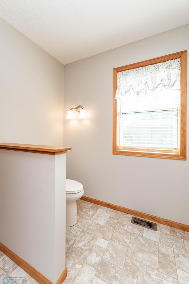 210 1st St, Arthur, ND 58006 - bathroom with baseboards and toilet