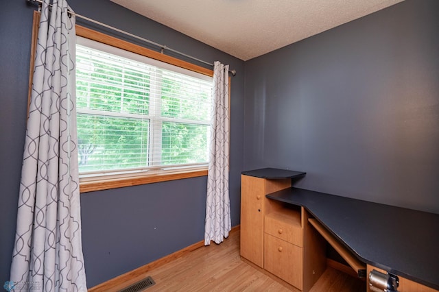 210 1st St, Arthur, ND 58006 - unfurnished office featuring wood finished floors and a textured ceiling