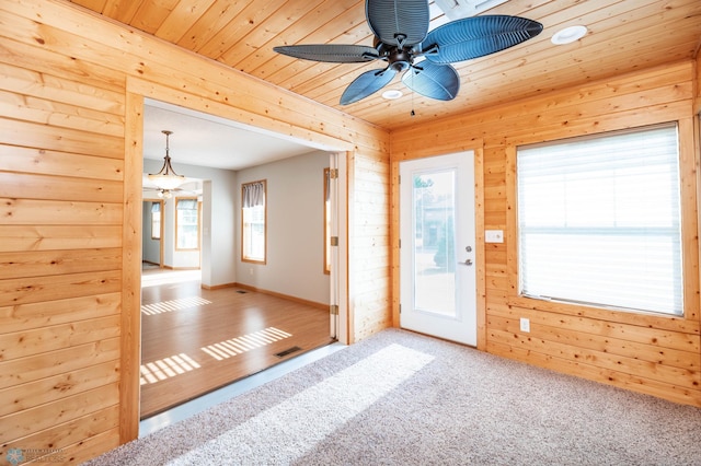 210 1st St, Arthur, ND 58006 - carpeted entryway featuring ceiling fan, wooden ceiling, and wood walls