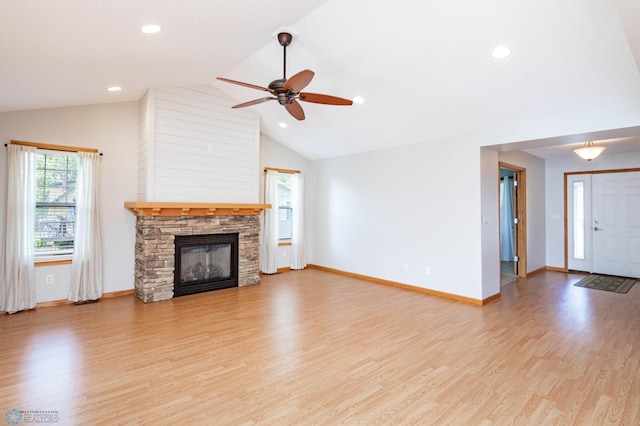 210 1st St, Arthur, ND 58006 - unfurnished living room with a ceiling fan, vaulted ceiling, a fireplace, light wood-style flooring, and recessed lighting