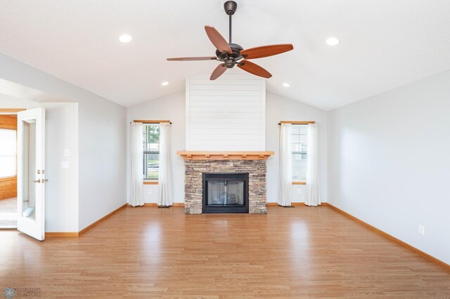 210 1st St, Arthur, ND 58006 - unfurnished living room with light wood-style flooring, lofted ceiling, a fireplace, a ceiling fan, and recessed lighting