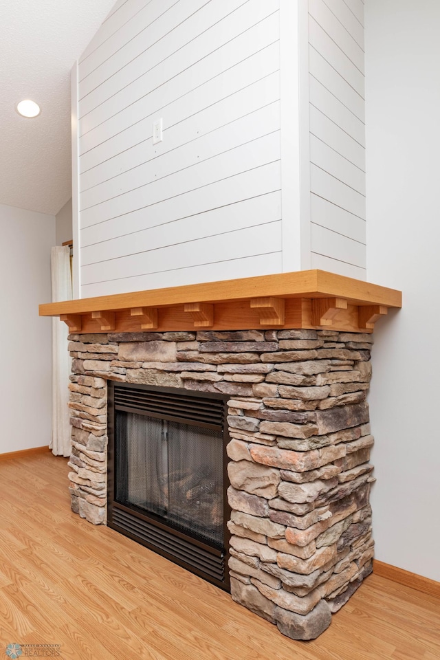 210 1st St, Arthur, ND 58006 - detailed view of a fireplace, wood finished floors, and recessed lighting
