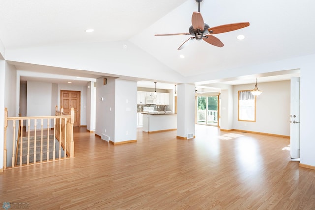 210 1st St, Arthur, ND 58006 - unfurnished living room featuring light wood finished floors, vaulted ceiling, recessed lighting, and a ceiling fan