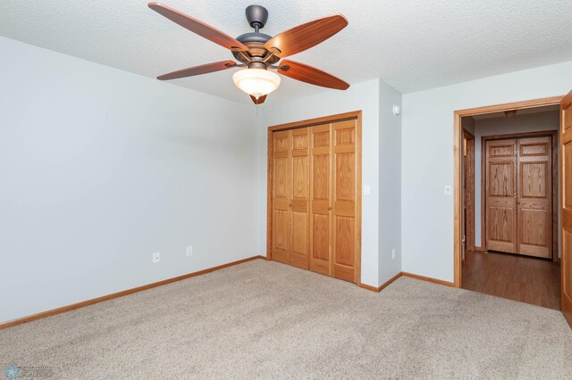 210 1st St, Arthur, ND 58006 - unfurnished bedroom with carpet, a closet, a ceiling fan, and a textured ceiling