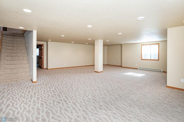 210 1st St, Arthur, ND 58006 - basement featuring baseboard heating, light colored carpet, stairway, and recessed lighting