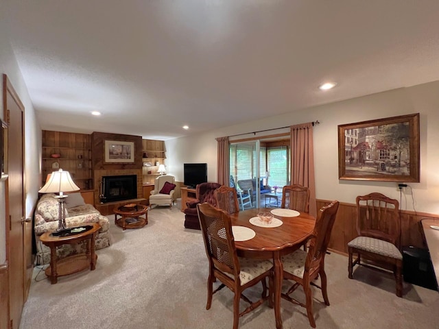 1804 7th St SW, Willmar, MN 56201 - carpeted dining area featuring a large fireplace, recessed lighting, and wooden walls