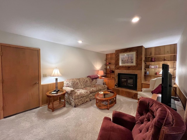 1804 7th St SW, Willmar, MN 56201 - living area featuring wood walls, carpet flooring, a glass covered fireplace, built in shelves, and wainscoting