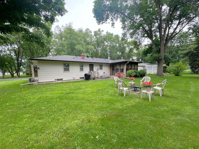 1804 7th St SW, Willmar, MN 56201 - back of property featuring an outdoor fire pit, a lawn, and a patio
