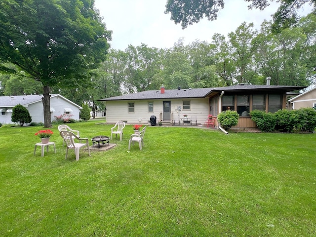 1804 7th St SW, Willmar, MN 56201 - back of house with a fire pit, a lawn, and entry steps