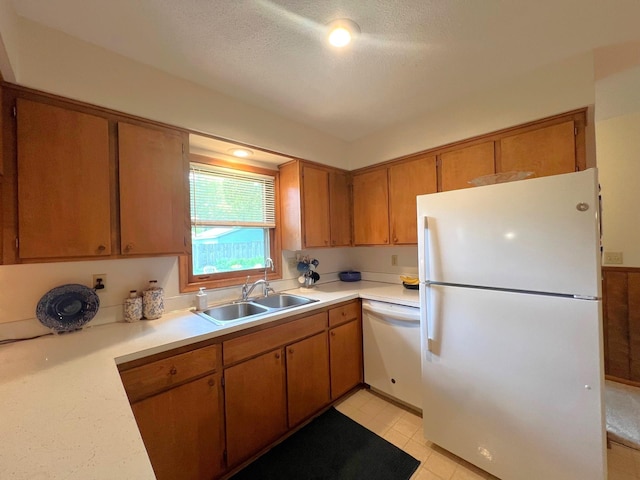 1804 7th St SW, Willmar, MN 56201 - kitchen with white appliances, light countertops, a textured ceiling, and brown cabinetry