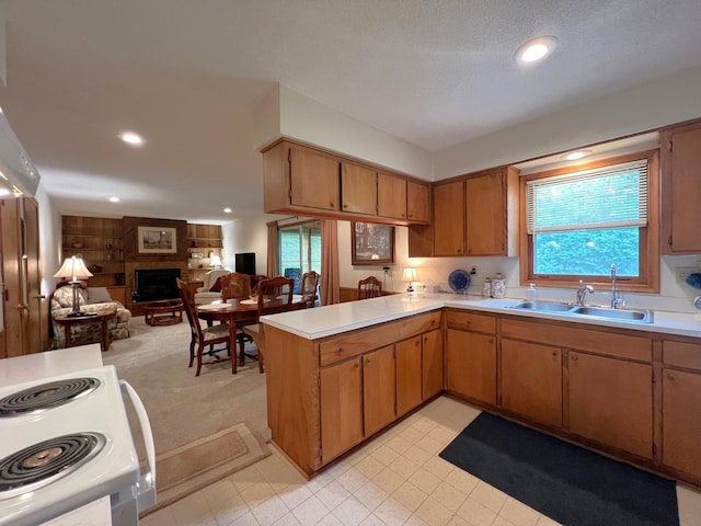 1804 7th St SW, Willmar, MN 56201 - kitchen with open floor plan, light countertops, a peninsula, a fireplace, and recessed lighting