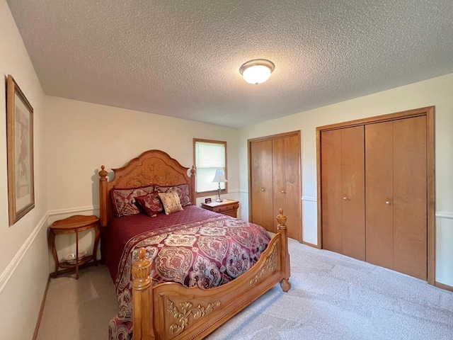 1804 7th St SW, Willmar, MN 56201 - bedroom with carpet floors, two closets, and a textured ceiling