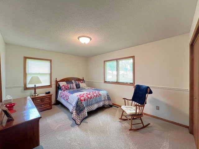 1804 7th St SW, Willmar, MN 56201 - bedroom featuring multiple windows, light carpet, and a textured ceiling