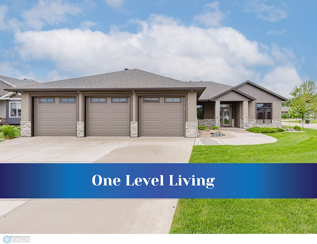 3629 Houkom Dr E, Fargo, ND 58078 - view of front of house with stone siding, driveway, an attached garage, and a front yard