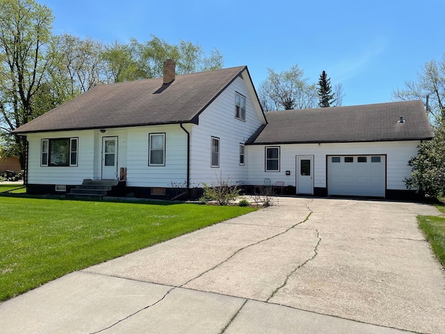912 3rd St NE, Roseau, MN 56751 - view of front facade featuring a chimney, a garage, asphalt driveway, a front lawn, and entry steps