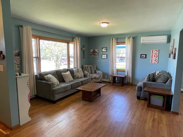 912 3rd St NE, Roseau, MN 56751 - living area featuring a wall unit AC and wood finished floors