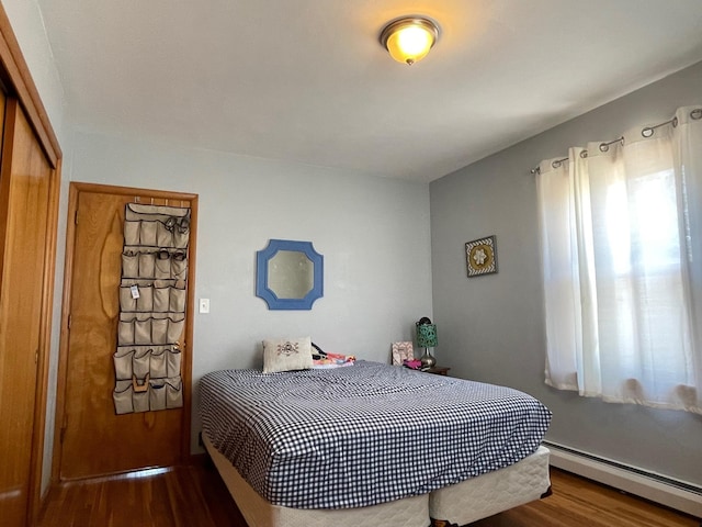 912 3rd St NE, Roseau, MN 56751 - bedroom featuring baseboard heating and wood finished floors
