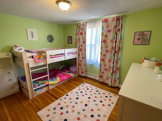 912 3rd St NE, Roseau, MN 56751 - bedroom with wood finished floors and baseboard heating