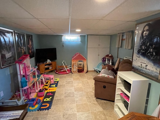 912 3rd St NE, Roseau, MN 56751 - rec room with a drop ceiling and light tile patterned floors