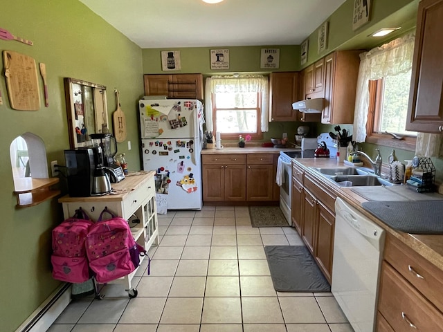 912 3rd St NE, Roseau, MN 56751 - kitchen featuring white appliances, a baseboard heating unit, light tile patterned flooring, under cabinet range hood, and brown cabinets