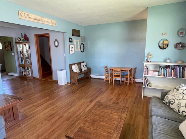 912 3rd St NE, Roseau, MN 56751 - living room featuring wood finished floors and a baseboard radiator