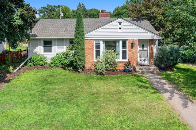 6045 Oakland Ave, Minneapolis, MN 55417 - view of front of property with roof with shingles, brick siding, and a chimney