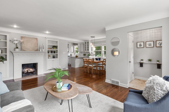 6045 Oakland Ave, Minneapolis, MN 55417 - living area with a brick fireplace, dark wood finished floors, and built in features
