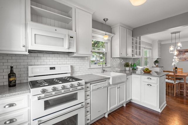 6045 Oakland Ave, Minneapolis, MN 55417 - kitchen featuring white appliances, white cabinets, backsplash, a peninsula, and plenty of natural light