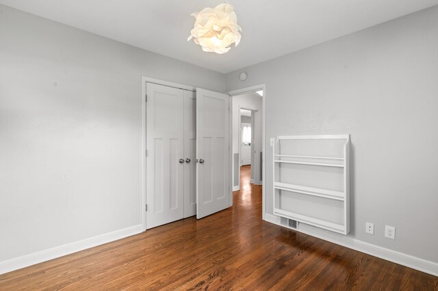 6045 Oakland Ave, Minneapolis, MN 55417 - unfurnished bedroom with wood finished floors, a chandelier, and a closet
